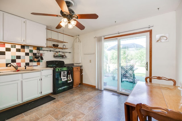 413 Weinland St, New Carlisle, OH 45344 - kitchen with black gas range, white cabinets, tasteful backsplash, and ceiling fan