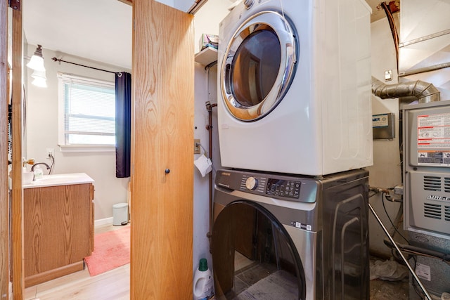 413 Weinland St, New Carlisle, OH 45344 - laundry room featuring stacked washer / dryer and light wood-type flooring