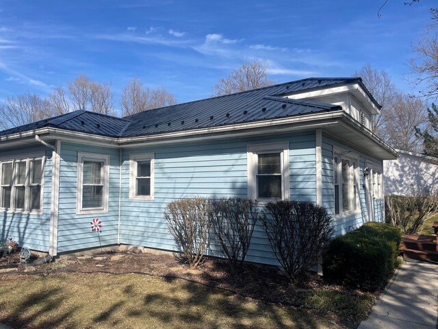 view of side of home with metal roof