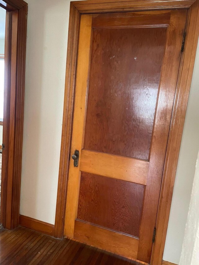details featuring baseboards and wood finished floors