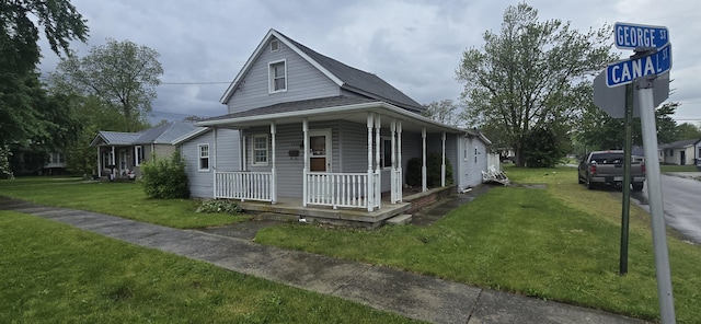 view of front of home featuring covered porch and a front lawn