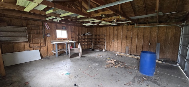 misc room featuring a garage and unfinished concrete flooring