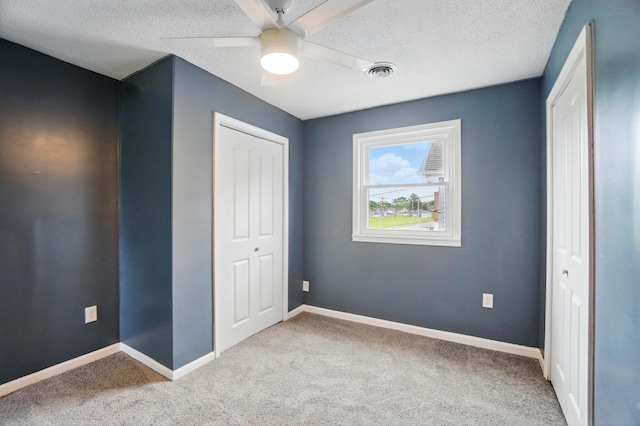 925 E St, Springfield, OH 45505 - unfurnished bedroom with a closet, carpet floors, a textured ceiling, and baseboards