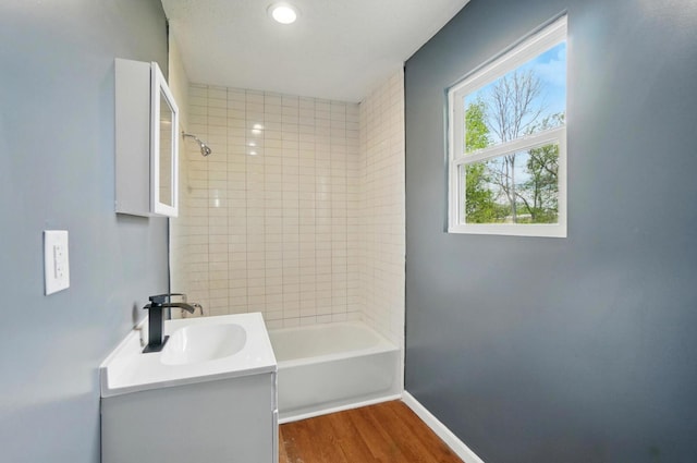925 E St, Springfield, OH 45505 - bathroom featuring vanity, wood finished floors, baseboards, and bathtub / shower combination