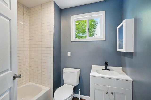 925 E St, Springfield, OH 45505 - bathroom featuring toilet, vanity, and tub / shower combination