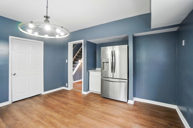 925 E St, Springfield, OH 45505 - kitchen featuring stainless steel fridge with ice dispenser, light wood finished floors, baseboards, and white cabinets