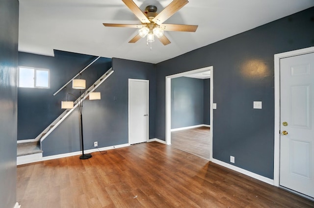 925 E St, Springfield, OH 45505 - unfurnished living room featuring a ceiling fan, baseboards, and wood finished floors