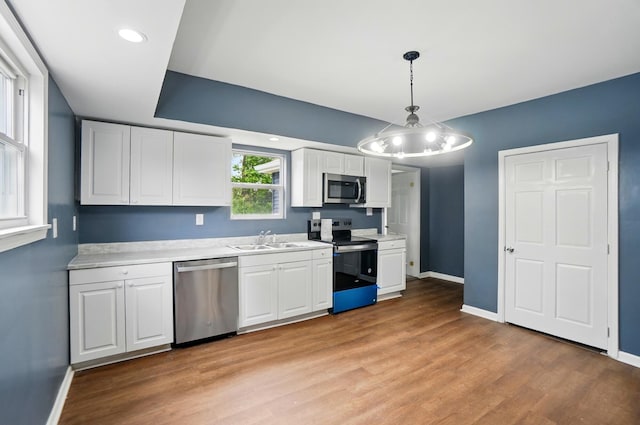 925 E St, Springfield, OH 45505 - kitchen with stainless steel appliances, a sink, light countertops, baseboards, and white cabinetry