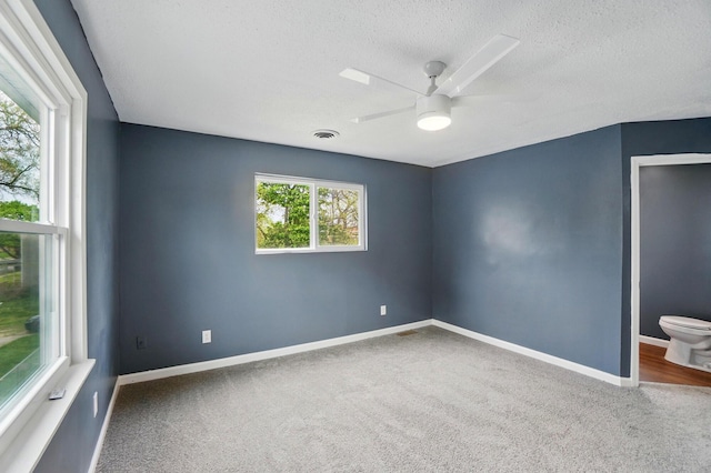 925 E St, Springfield, OH 45505 - carpeted spare room featuring a textured ceiling, a ceiling fan, and baseboards