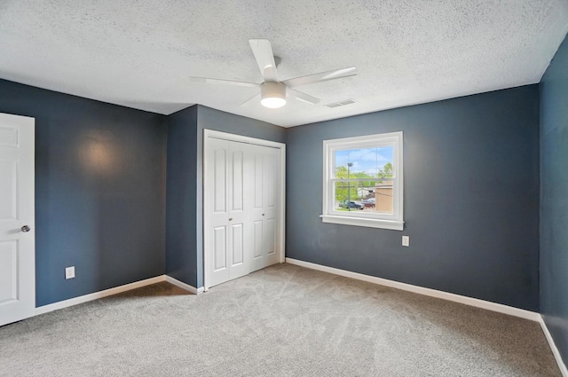 925 E St, Springfield, OH 45505 - unfurnished bedroom with a closet, carpet flooring, a textured ceiling, and baseboards
