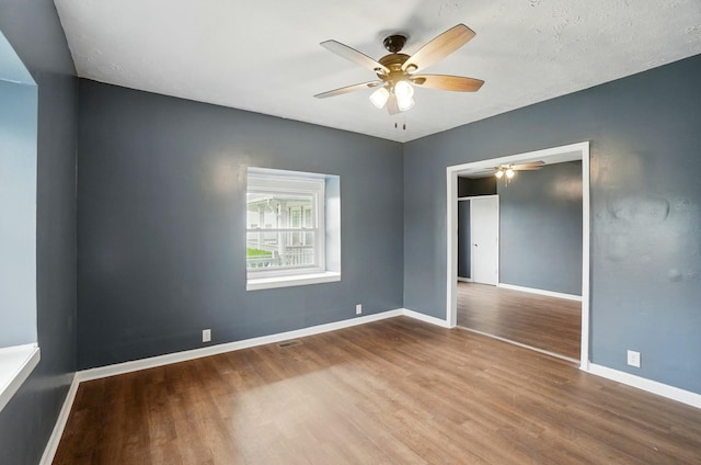 925 E St, Springfield, OH 45505 - empty room featuring wood finished floors, a ceiling fan, and baseboards