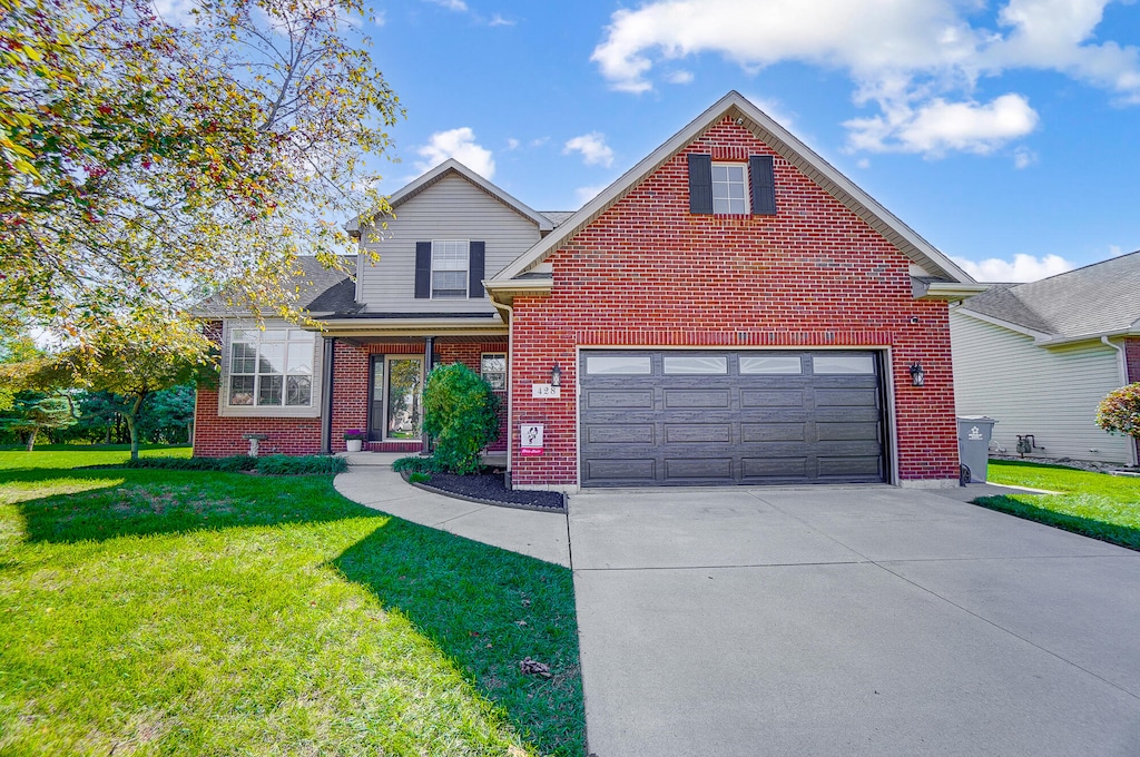 front of property with a garage and a front lawn