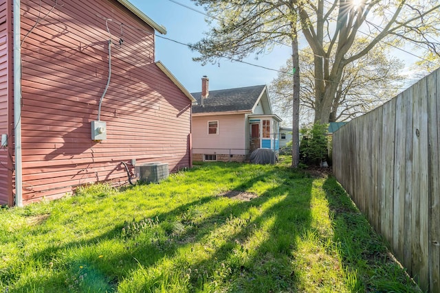 exterior space featuring central AC and fence