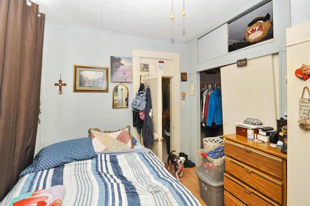 bedroom with a closet and wood finished floors