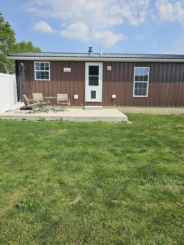 11524 Powhattan Path, Lakeview, OH 43331 - rear view of house with a patio area, a lawn, and metal roof