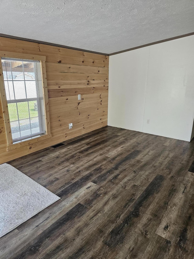 11524 Powhattan Path, Lakeview, OH 43331 - spare room featuring wood finished floors, ornamental molding, and a textured ceiling