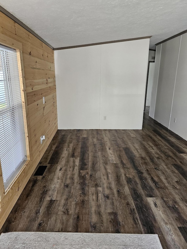 11524 Powhattan Path, Lakeview, OH 43331 - unfurnished room with ornamental molding, wood finished floors, and wood walls