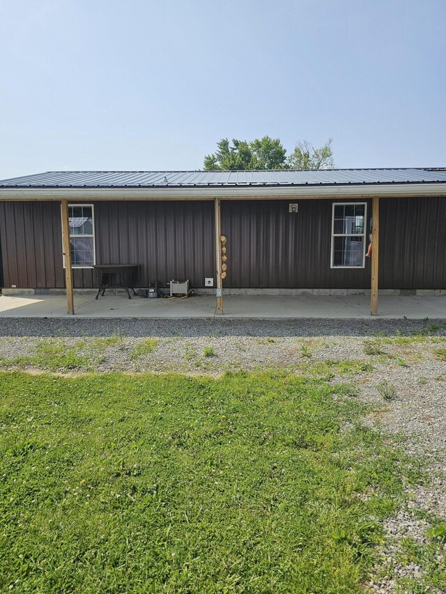 11524 Powhattan Path, Lakeview, OH 43331 - view of property exterior with metal roof, board and batten siding, and a yard