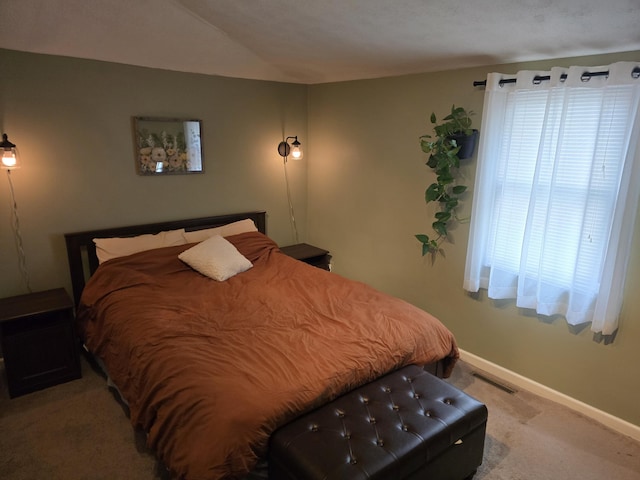 bedroom featuring vaulted ceiling, carpet flooring, baseboards, and visible vents