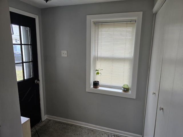 doorway to outside with baseboards