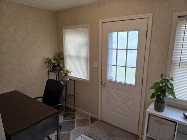 doorway featuring baseboards