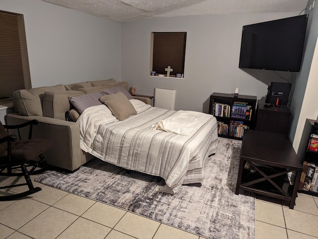 bedroom featuring a textured ceiling and tile patterned flooring