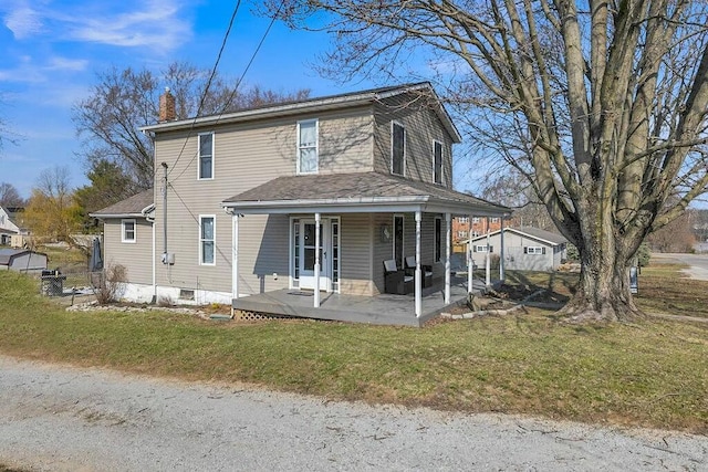 exterior space featuring a front yard, covered porch, and a chimney