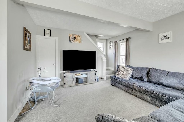 living room featuring beam ceiling, a textured ceiling, carpet, baseboards, and stairs