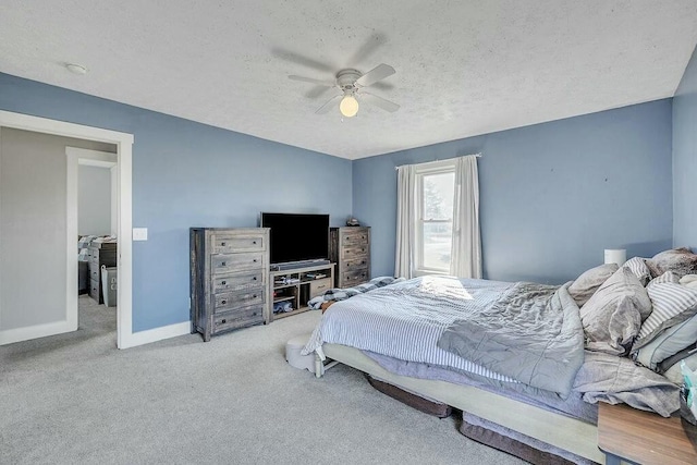 carpeted bedroom featuring baseboards, a textured ceiling, and ceiling fan