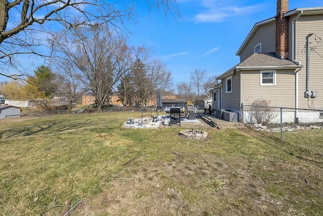 view of yard with a patio, a fire pit, and fence