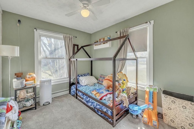 bedroom with carpet flooring, a ceiling fan, and a baseboard radiator