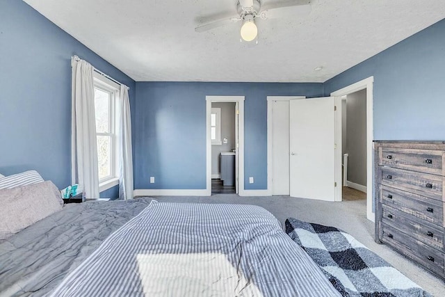 bedroom featuring ensuite bath, ceiling fan, baseboards, and carpet