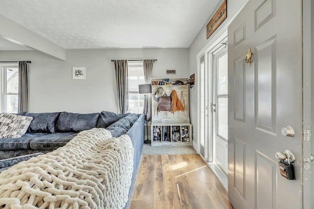 living room featuring a textured ceiling and light wood-style flooring