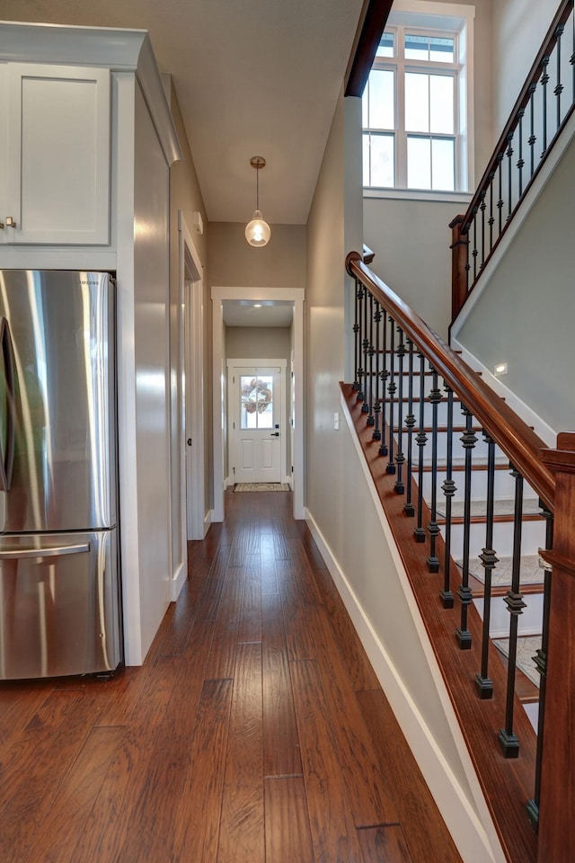 2737 Executive Dr, Troy, OH 45373 - foyer entrance with baseboards, dark wood finished floors, and stairway