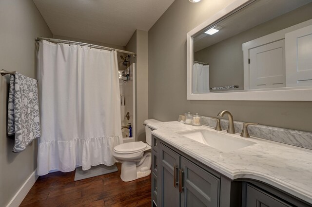 2737 Executive Dr, Troy, OH 45373 - full bathroom with vanity, wood finished floors, toilet, and shower / bath combination with curtain