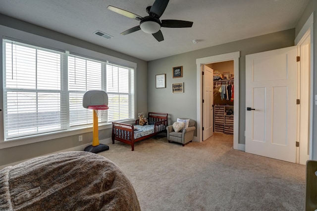 2737 Executive Dr, Troy, OH 45373 - bedroom featuring light colored carpet, a walk in closet, a ceiling fan, and baseboards