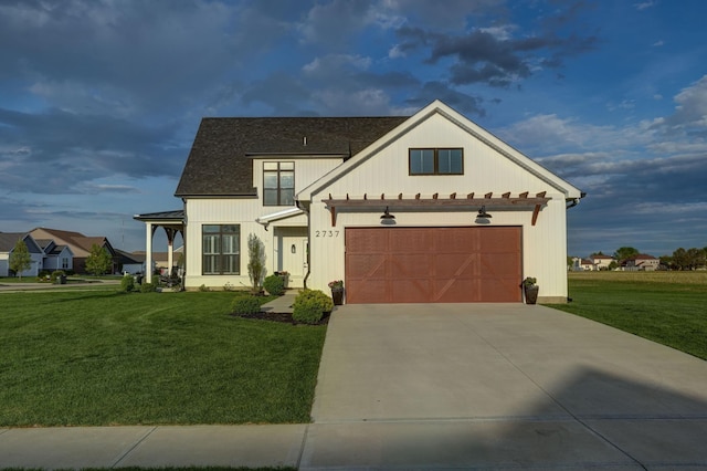 2737 Executive Dr, Troy, OH 45373 - modern inspired farmhouse with a front lawn, concrete driveway, and a garage