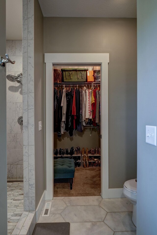 2737 Executive Dr, Troy, OH 45373 - full bathroom with a tile shower, toilet, and a spacious closet