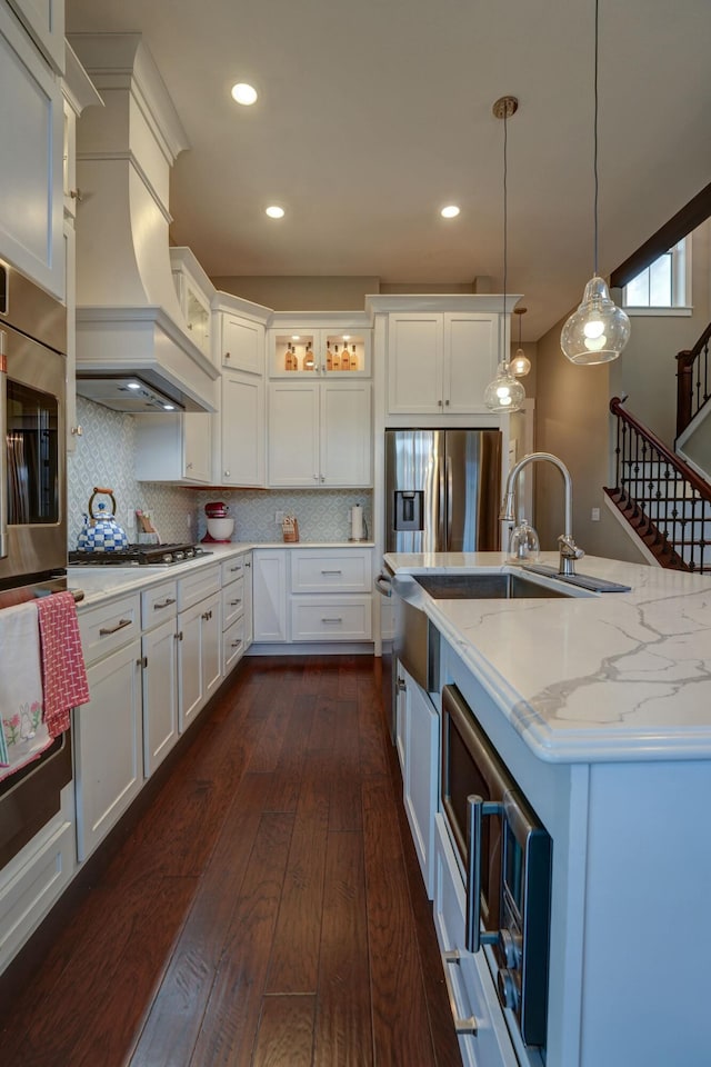 2737 Executive Dr, Troy, OH 45373 - kitchen with stainless steel appliances, dark wood-style floors, white cabinetry, decorative light fixtures, and recessed lighting