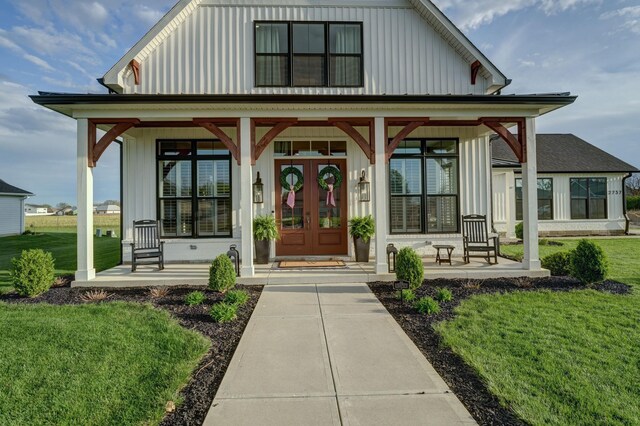 2737 Executive Dr, Troy, OH 45373 - view of front of home featuring a porch, board and batten siding, and a front lawn