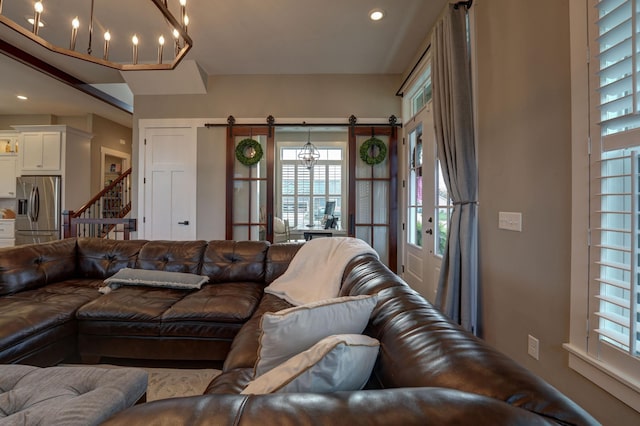 2737 Executive Dr, Troy, OH 45373 - living area featuring a barn door, recessed lighting, stairs, and a chandelier