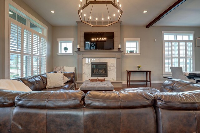 2737 Executive Dr, Troy, OH 45373 - living area with healthy amount of natural light, a premium fireplace, baseboards, a chandelier, and recessed lighting
