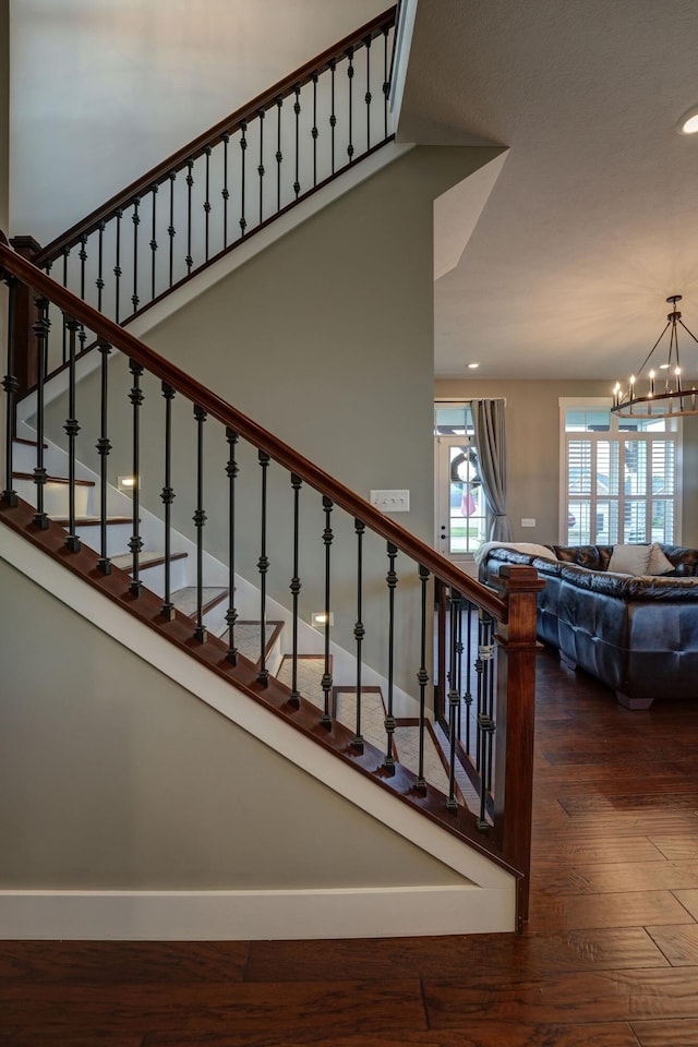 2737 Executive Dr, Troy, OH 45373 - stairway with a chandelier, wood finished floors, recessed lighting, and baseboards