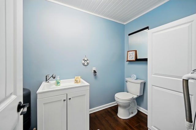 14506 Maple Ave, Lakeview, OH 43331 - half bathroom featuring toilet, vanity, wood finished floors, baseboards, and ornamental molding