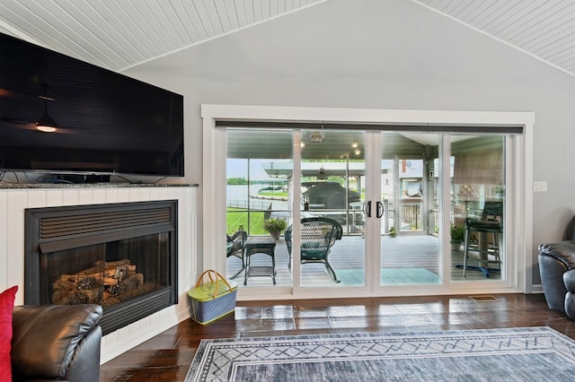 14506 Maple Ave, Lakeview, OH 43331 - living area featuring vaulted ceiling, wood finished floors, and a fireplace