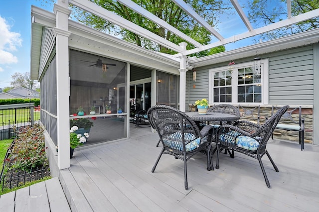 14506 Maple Ave, Lakeview, OH 43331 - deck with outdoor dining area, a sunroom, and a ceiling fan