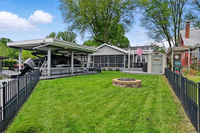 14506 Maple Ave, Lakeview, OH 43331 - view of yard with a fire pit, a sunroom, and a carport