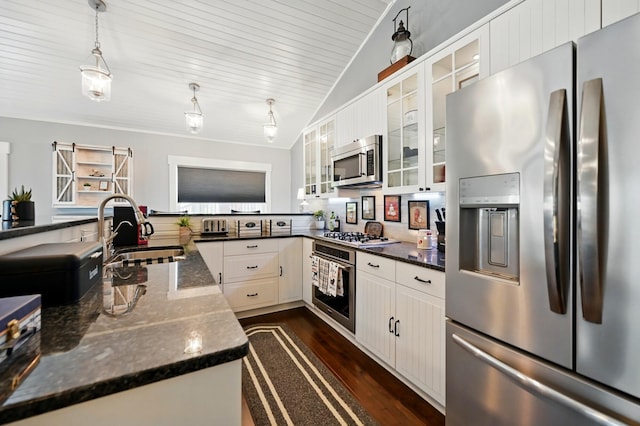 14506 Maple Ave, Lakeview, OH 43331 - kitchen with stainless steel appliances, a sink, lofted ceiling, dark wood-style flooring, and decorative light fixtures
