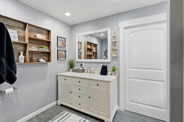 14506 Maple Ave, Lakeview, OH 43331 - bathroom featuring vanity, wood finished floors, baseboards, and recessed lighting