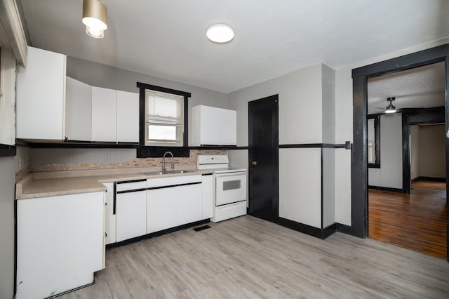 317 S Miami Ave, Xenia, OH 45385 - kitchen featuring white appliances, a sink, light countertops, light wood-style flooring, and white cabinets